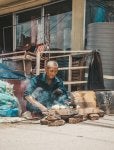 In Nepal a man cooks food outside