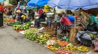 Women selling fresh fruits and vegetables at a market in Mombasa, Kenya.