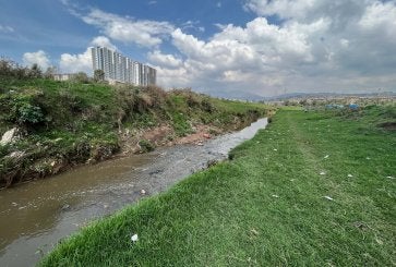 River alongside city.