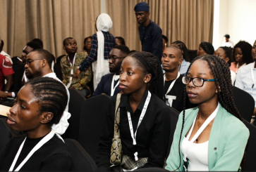 Young people in a conference room.