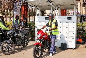Riders swap batteries at a charging station