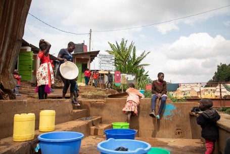 Kibera laundry pad allows women to watch their children while doing their work