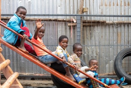 Children play on a slide at a KDI public space.