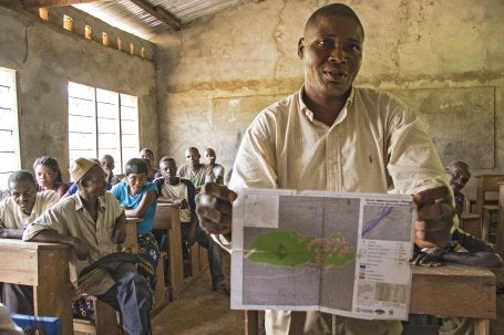 In the village of Ilanga, DRC, a man showcases a map created by his community in order to better delimit the boundaries of particular land concessions on their traditional lands. 