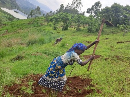 Local community member in Camp Saio neighborhood of Bukavu prepares land for tree planting along the steep slopes near the Ruzizi I Hydropower Dam