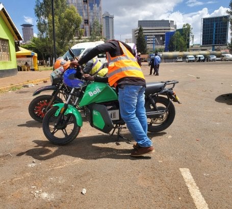 A rider inspects an electric motorcycle in Nairobi, where electric two-wheelers are emerging as an important solution for reducing transport emissions and improving urban mobility in Kenya.