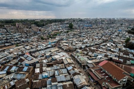 Aerial view of Mathare, a densely populated informal settlement, with numerous metal-roofed structures.