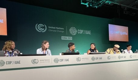 People discuss climate action at the COP28 climate summit in Dubai.