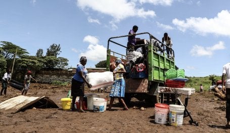 People load a truck with their belongings after heavy rainfall caused floods in Kenya.