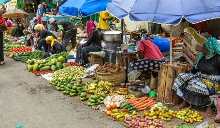 Women selling fresh fruits and vegetables at a market in Mombasa, Kenya.