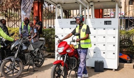 Riders swap batteries at a charging station