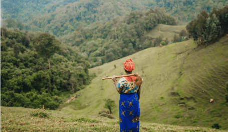 Woman stading next to a forest in Rwanda