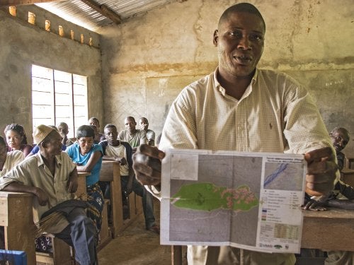 In the village of Ilanga, DRC, a man showcases a map created by his community in order to better delimit the boundaries of particular land concessions on their traditional lands. 
